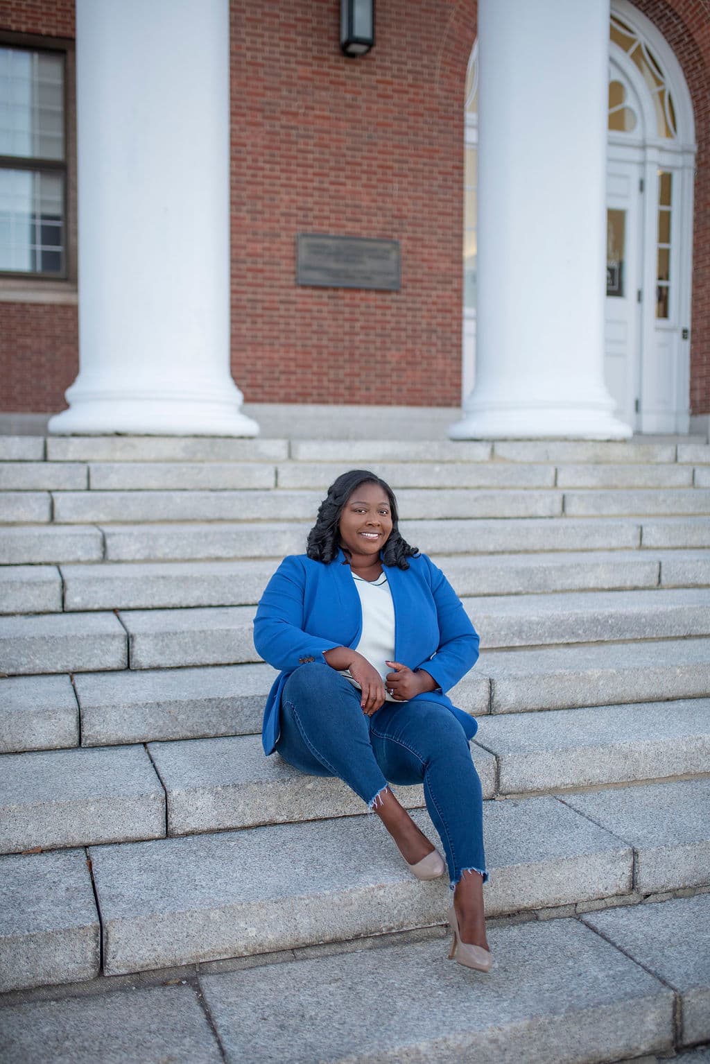 Personal branding portrait of a woman on brick building steps