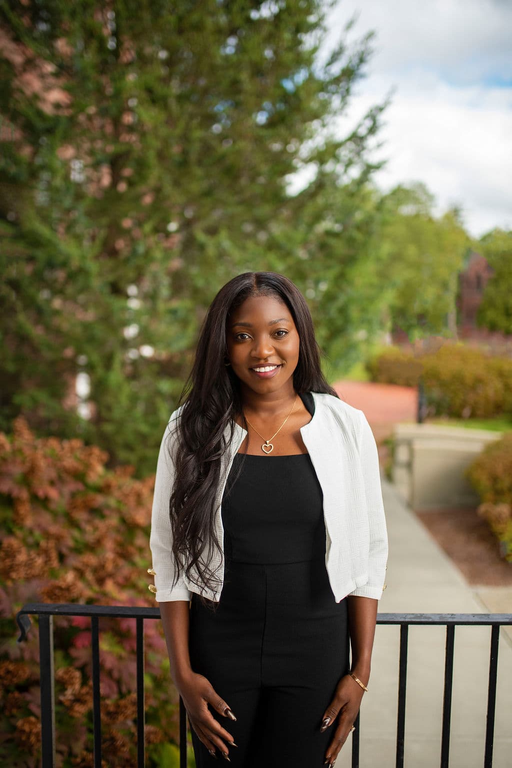 Professional woman in a white blazer, outdoor headshot